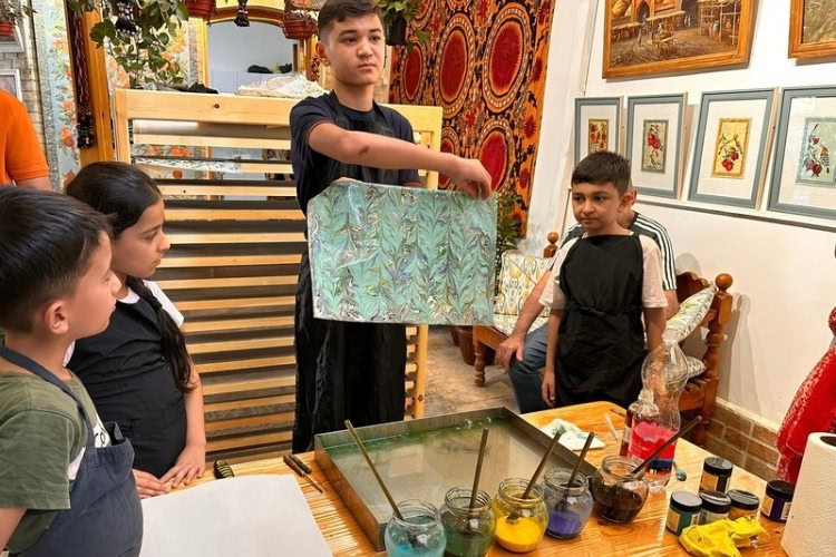 Children exhibiting their paintings at the Ustoz Shogird Center. Photo by Steve Sindiong