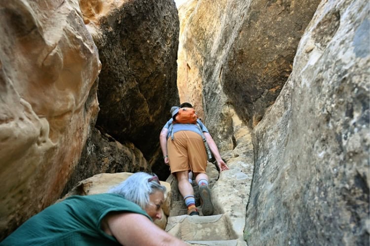 Stone-cut steps in narrow passageways lead you to Cliff House. Photo by Tab Hauser