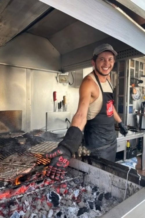 The grill master at Luis dos Frangos, Sao Bras de Alportel, Portugal. Photo by Hayley Clark