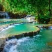 The Kuang Si waterfall is a famous destination in Laos. Photo by iStock/Torjrtrx