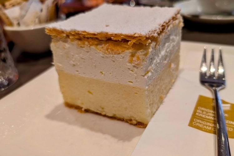 Lake Bled's famed cream cake is four layers of miraculous pastry making packed into 343 cubic centimeters. Photo by [Author's Name]
