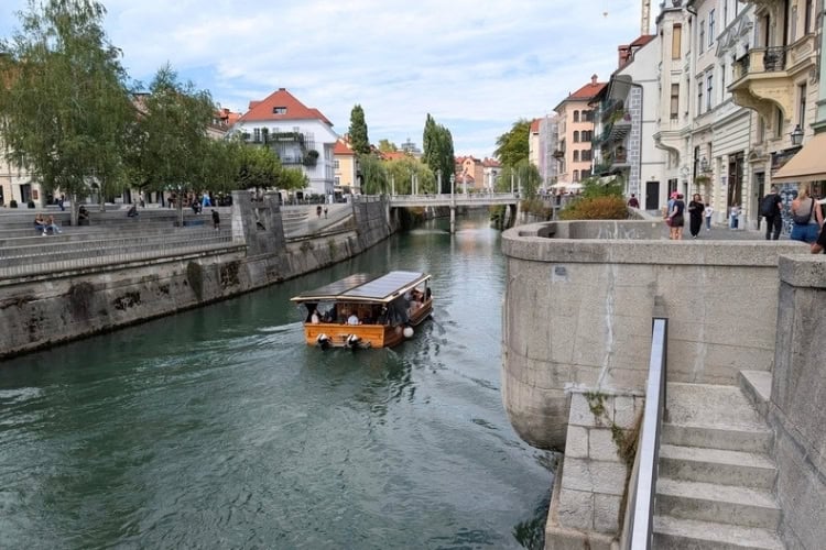 The Ljubljanica River in Ljubljana, Slovenia, with its streets lined with historic architecture and restaurants serving fresh food and wine. Photo by Craig Stoltz