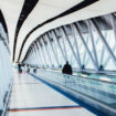 Travelers walking through an airport corridor. Photo by Negative Space, Pexels