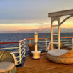Sunset over the Corsican mountains from the deck of a ship. Photo by Diana Ballon
