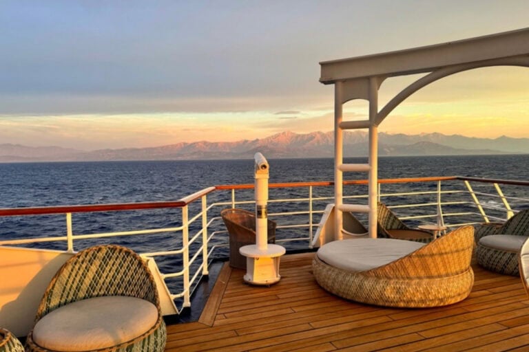 Sunset over the Corsican mountains from the deck of a ship. Photo by Diana Ballon