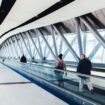 Travelers walking through an airport corridor. Photo by Negative Space, Pexels