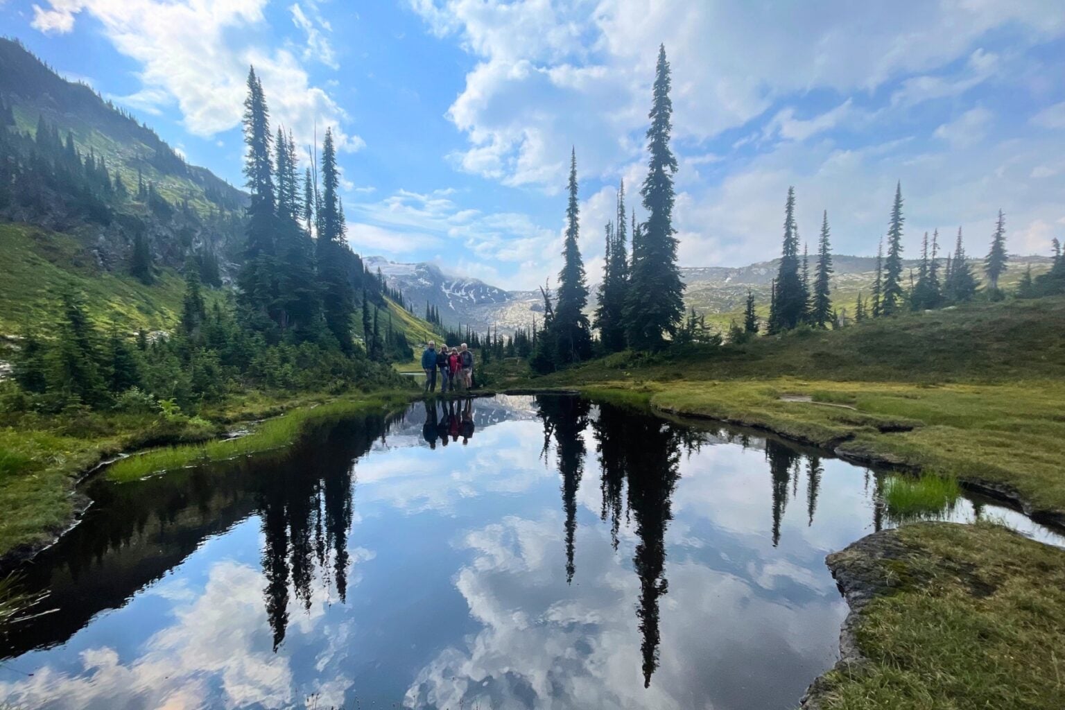Alpine lakes mirror the Selkirk Mountains. Photo by guide, Tate