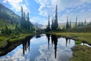 Alpine lakes mirror the Selkirk Mountains. Photo by guide, Tate