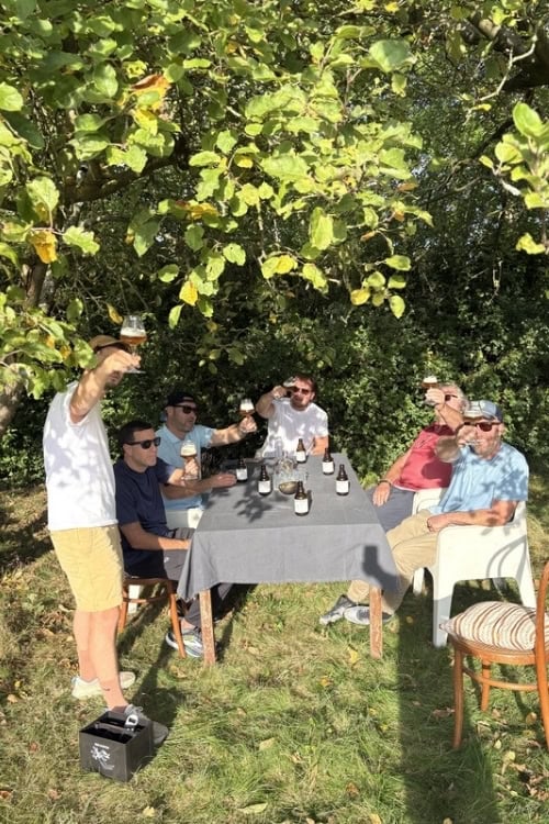 A beer tasting under the fruit trees on a summer afternoon. Photo by Joris Desplenter