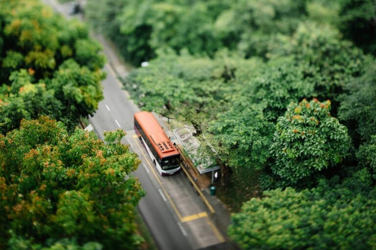 Bus at a stop from above. Photo by CHUTTERSNAP, Unsplash