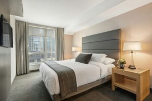 Hotel room with white bed linen. Photo by Point3D Commercial Imaging Ltd., Unsplash