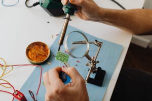 Repairing of circuit board. Photo by Ka Boom Pics, Pexels