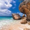 Turquoise water meets weathered limestone along Bonaire’s coast. Photo by johnandersonphoto from Getty Images via Canva