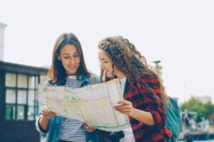 Two women exploring the town with backpacks. Photo by Vitaly Gariev, Unsplash